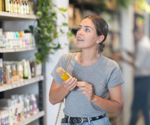 Positive,Young,Girl,Carefully,Examining,Variety,Of,Organic,Cosmetics,In